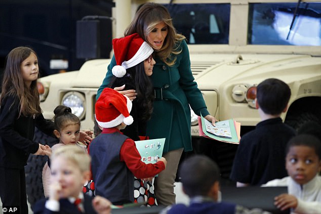474CCA3100000578-5176441-One_girl_wearing_a_Santa_hat_got_a_hug_from_the_first_lady_whose-a-16_1513203151377.jpg